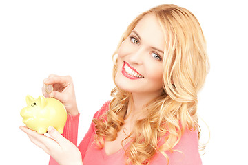 Image showing lovely woman with piggy bank and money