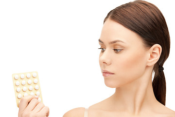 Image showing young beautiful woman with pills