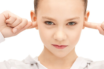 Image showing teenage girl with fingers in ears