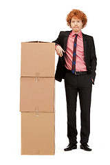 Image showing attractive businessman with big boxes