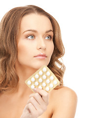 Image showing young beautiful woman with pills