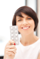 Image showing young beautiful woman with pills