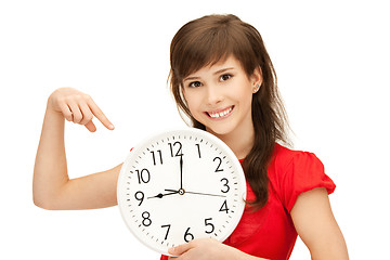 Image showing teenage girl holding big clock