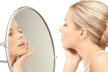 Image showing beautiful woman with pearl beads and mirror