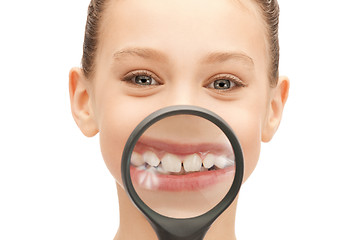 Image showing teenage girl with magnifying glass showing teeth