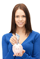 Image showing lovely woman with piggy bank and money