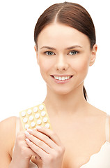 Image showing young beautiful woman with pills