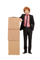 Image showing attractive businessman with big boxes