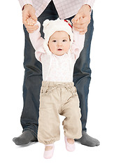 Image showing baby making first steps with father help