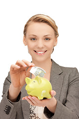 Image showing lovely woman with piggy bank and money