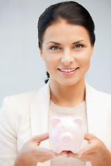 Image showing lovely woman with piggy bank