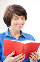 Image showing happy and smiling woman with book