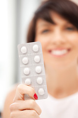 Image showing young beautiful woman with pills