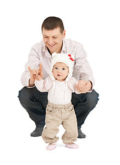 Image showing baby making first steps with father help