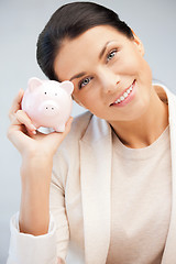 Image showing lovely woman with piggy bank