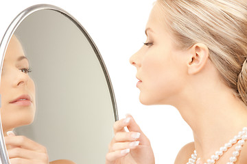 Image showing beautiful woman with pearl beads and mirror