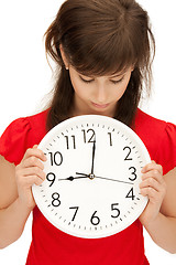 Image showing teenage girl holding big clock