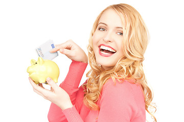 Image showing lovely woman with piggy bank and money