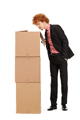 Image showing attractive businessman with big boxes