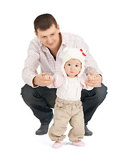 Image showing baby making first steps with father help