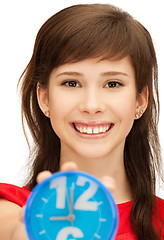 Image showing teenage girl holding alarm clock