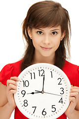 Image showing teenage girl holding big clock