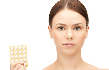 Image showing young beautiful woman with pills