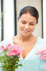 Image showing lovely housewife with flower