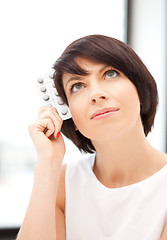 Image showing young beautiful woman with pills