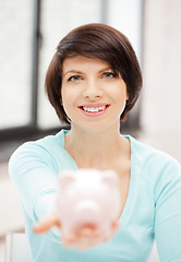 Image showing lovely woman with piggy bank