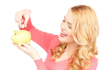 Image showing lovely woman with piggy bank and money