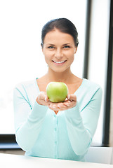 Image showing lovely housewife with green apple