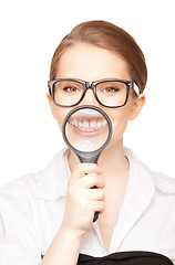 Image showing woman with magnifying glass showing teeth