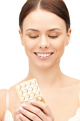 Image showing young beautiful woman with pills