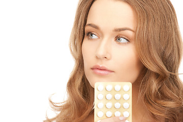 Image showing young beautiful woman with pills