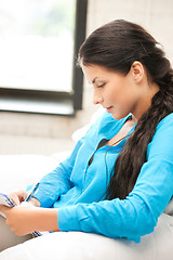 Image showing calm woman with big notepad