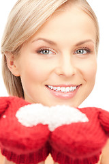 Image showing woman in mittens with snow