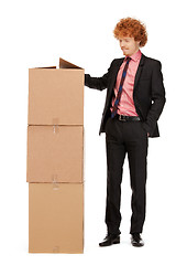 Image showing attractive businessman with big boxes