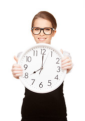 Image showing woman holding big clock