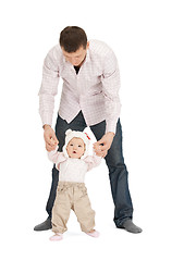 Image showing baby making first steps with father help