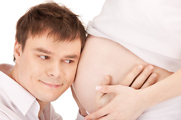 Image showing male face and pregnant woman belly