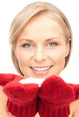 Image showing woman in mittens with snow