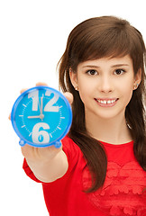 Image showing teenage girl holding alarm clock