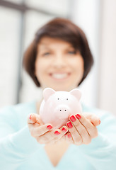 Image showing lovely woman with piggy bank