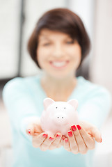 Image showing lovely woman with piggy bank