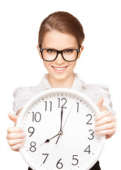 Image showing woman holding big clock