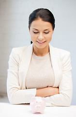 Image showing lovely woman with piggy bank