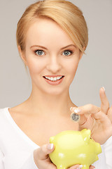 Image showing lovely woman with piggy bank and money