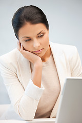 Image showing pensive woman with laptop computer