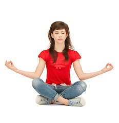 Image showing calm attractive teenage girl in lotus pose